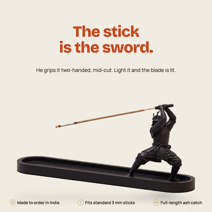 RONIN samurai incense holder — matte black 3D-printed figure holding a burning incense stick over a 250 mm ash dish