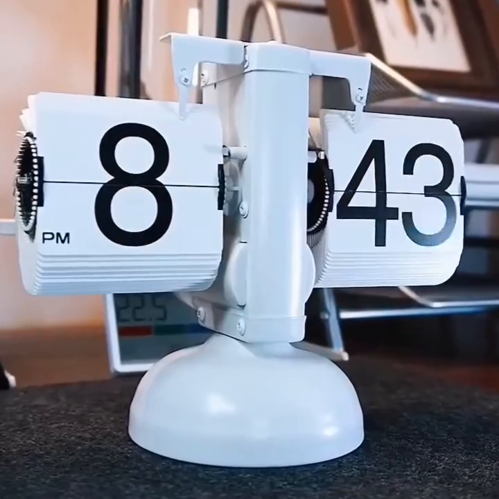 Painted-white PageClock physical flip-card display; real source-video frame