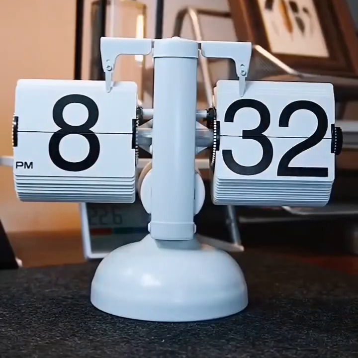Painted-white PageClock body and round pedestal; real source-video frame